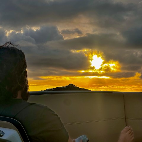 a person sitting in front of a body of water