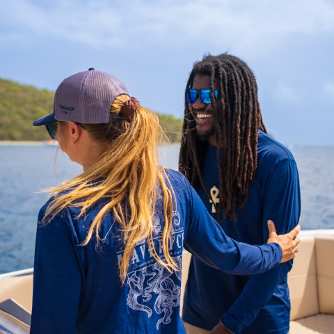 a woman standing next to a body of water